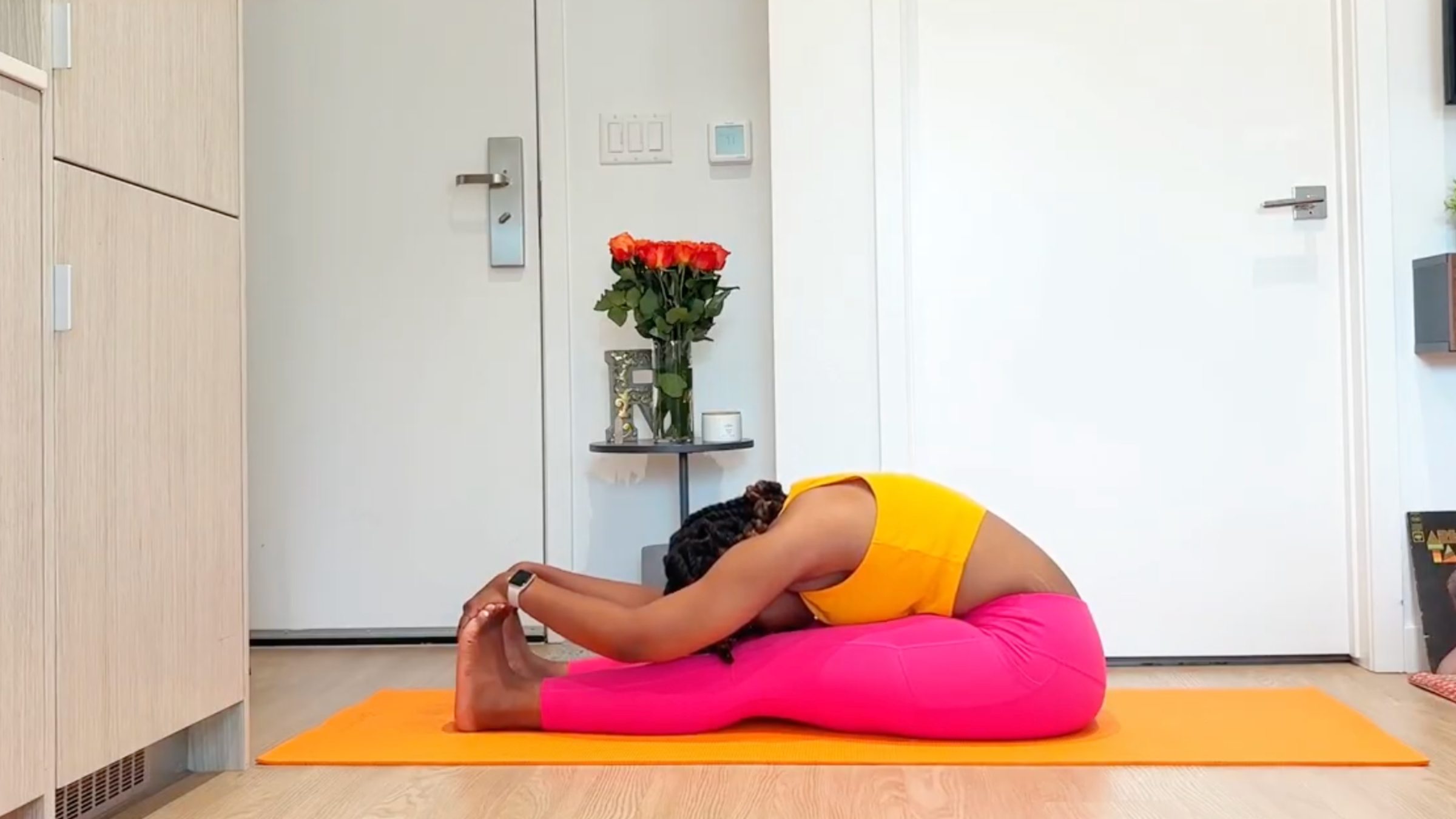 Yoga teacher practicing Seated Forward Bend
